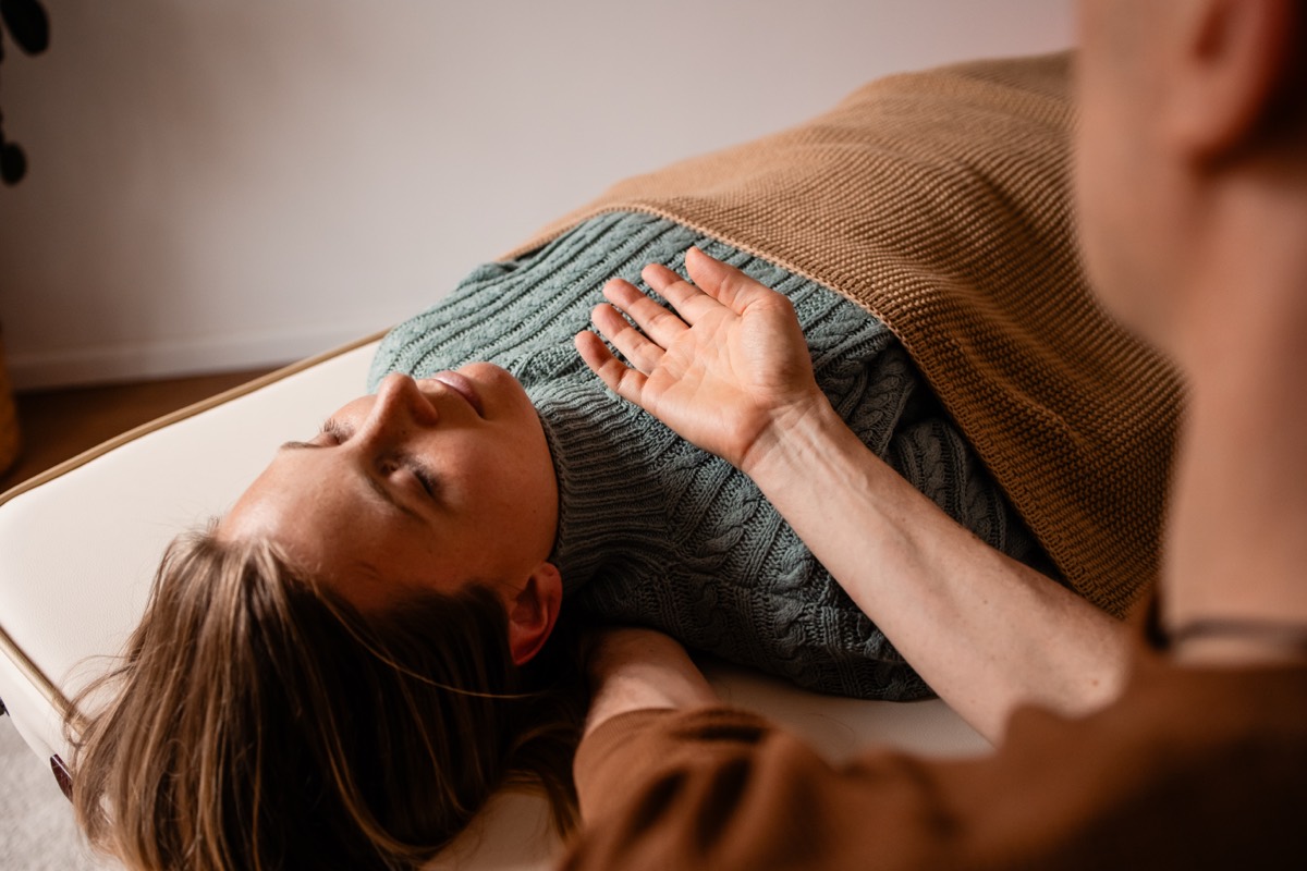 Gentle hands-on contact at the chest, settling the nervous system